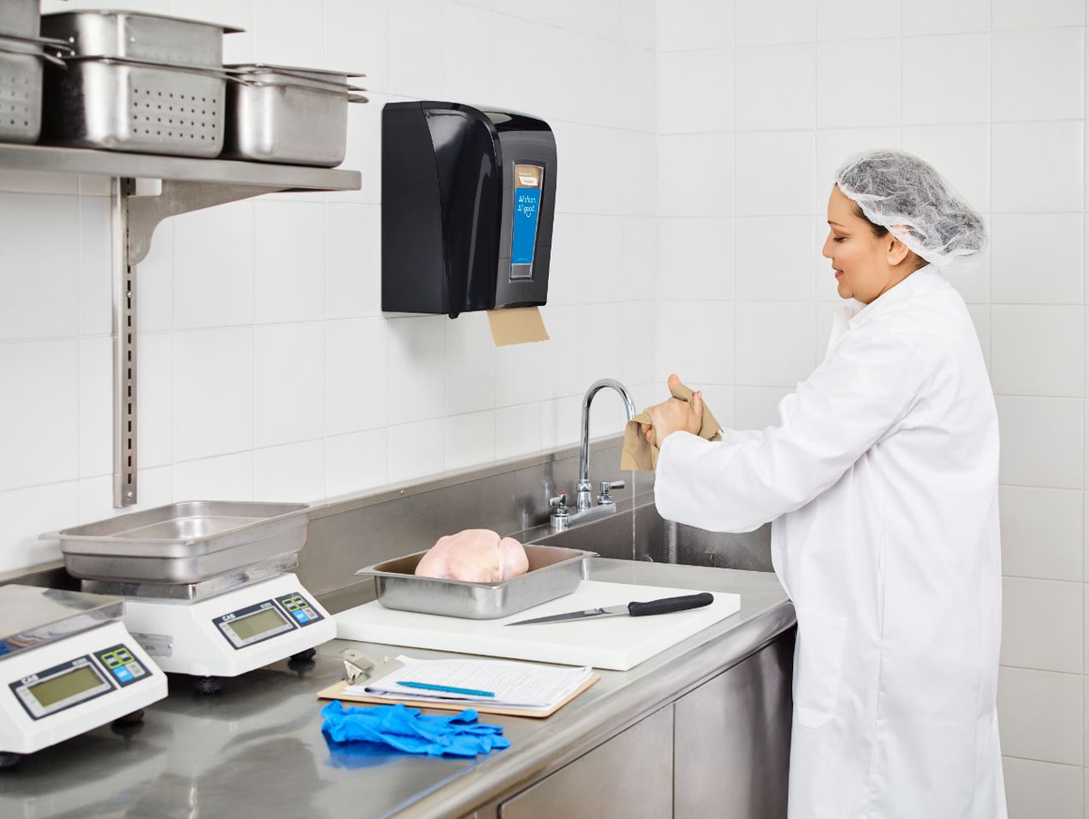 Cook washing hands in an industrial kitchen